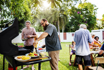 Diverse people enjoying barbecue party together - obrazy, fototapety, plakaty