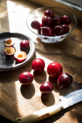 Closeup of fresh plums on wooden table