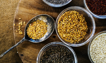 Aerial of seeds superfood on wooden board and spoon
