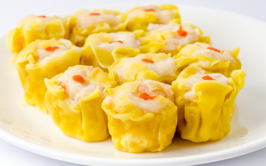 Chinese steamed shrimp dumplings on white dish