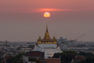Golden Mountain with  the sun on the top at Wat Saket, Thailand