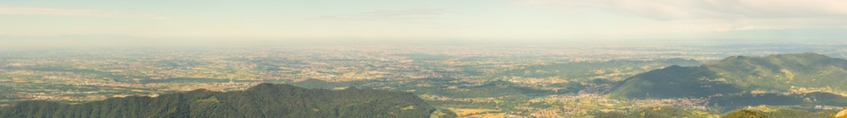 Great landscape on the Padana plain in summer time. Panorama from Linzone Mountain, Bergamo, Italy. 