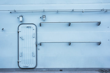 Battleship door with metal handrails and light bulbs background