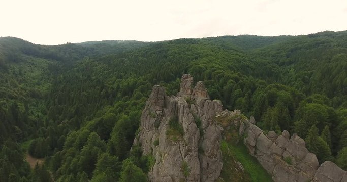 Fly Over Rocks above Forest