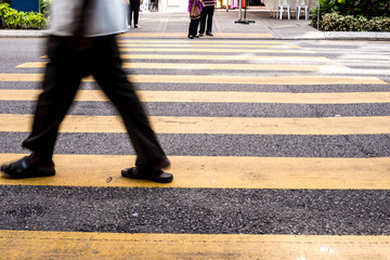 Motion Blur - People crossing the road. Blurry effect to illustrate movement