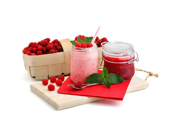 Raspberry smoothies, raspberry jam and a basket with ripe raspberries on a white background.