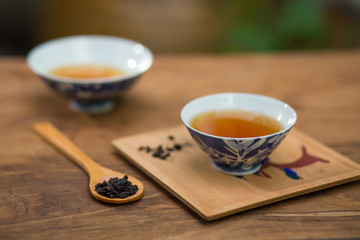 Tea cup and teapot on wooden table , close-up.