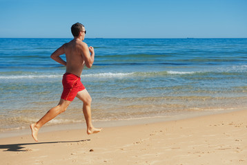 man running along the coast