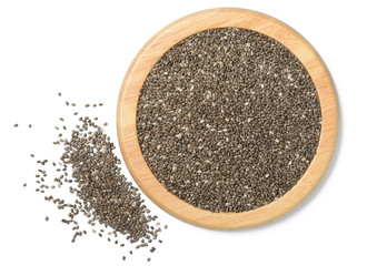 chia seeds in the wooden plate, isolated on white, top view