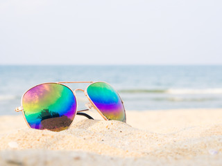 sunglasses on the beach with sea and sailboat backround, Concept of summer traveling