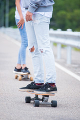 Young couple having fun with skateboards