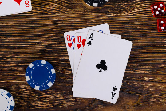 A good set of cards on a wooden table, to win