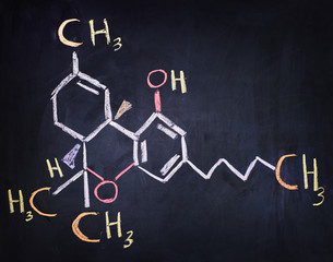Tetrahydro-cannabinol (THC) formula written on a black board