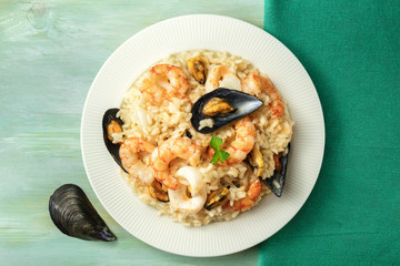 Seafood risotto plate on teal textures with copyspace