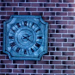 A vintage clock on a brick wall.