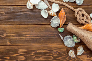 Fototapeta na wymiar Seashells border on wood. Marine background