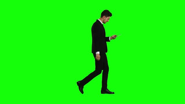 Businessman is going to work and prints important messages. Green screen Side view