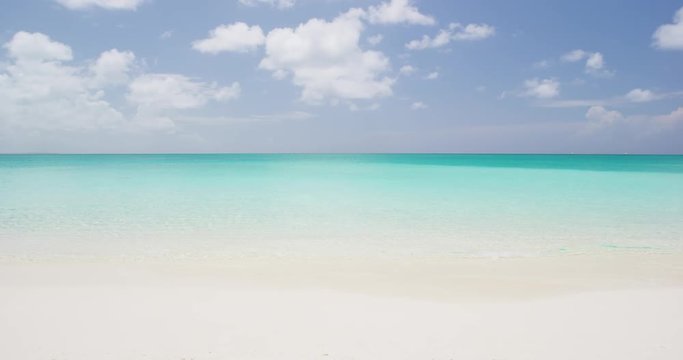 Beach background - Caribbean beach with turquoise water and white sand beach and blue sky. SLOW MOTION. RED EPIC.