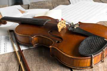 Sheet music and violin on wooden table