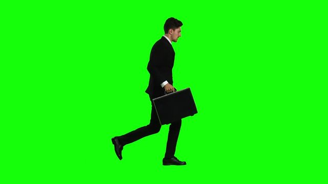Man goes to work, understands that he is late and begins to run. Green screen