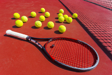 Tennis balls and racket on the grass court