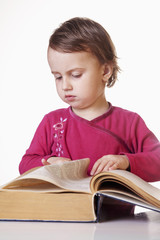 Difficult education. Beautiful little little child girl learns to read (success, education,  development)