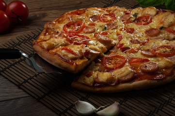 Hot pizza slice with melting cheese on a rustic wooden table