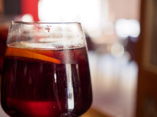 Close-up macro detail of a wine glass containing sangria with an orange slice, a traditional Spanish cocktail. Valencia, Spain. Travel and beverage concept.