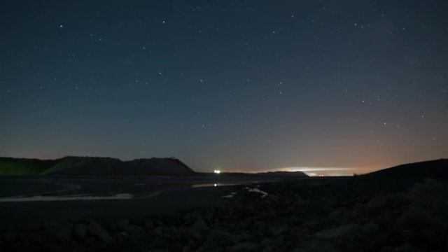 Salt piles, a view of the mountains of sand and salt. Night Timelapse. Blurred background.
