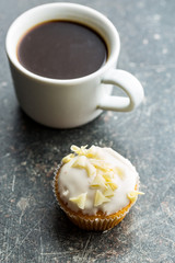Tasty cupcake and coffee cup.