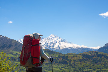 Confident woman traveler stands on the mountain plateau