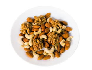 Different nuts lie on a plate.