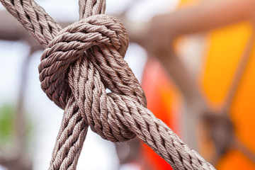 Fototapeta na wymiar Close-up of rope knot line tied together with playground background
