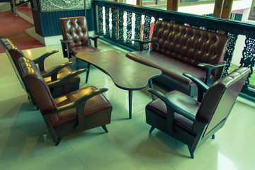 Old leather sofas, living room vintage filter