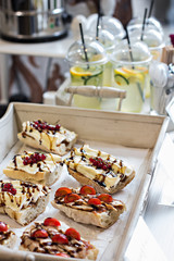 Lemonade and sandwiches at a party. A table with snacks.