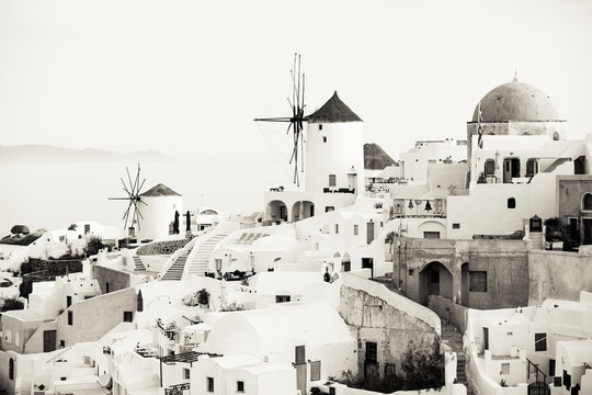 Traditional Oia windmills in Santorini, sepia toned black and white photo
