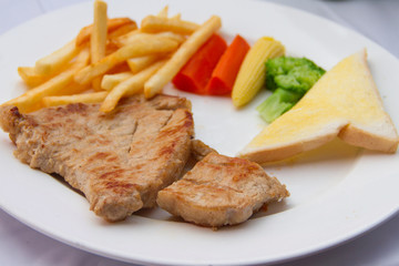 Pork steak in white plate