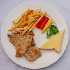 Pork steak in white plate