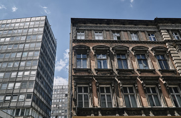 A facade of an Art Nouveau townhouse next to a modernist building in Poznan.