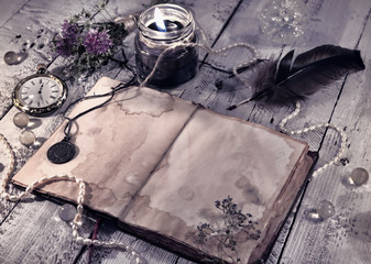 Retro styled still life with old diary, black candle and mystic objects. Mystic and occult still...