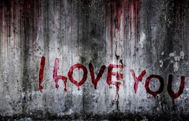 Write a message I love you on bloody background scary old wall, concept of disappointed in love and...