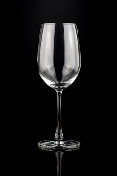 Empty wine glass isolated on a black background.