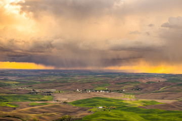 Amazing sunset sky over the green hills. Plowed fields, an incredible drawing of the earth. Pine Ridge Trail, Kamiak Butte State Park, Whitman County, Washington, USA