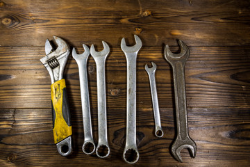 Old wrench tools on wooden background