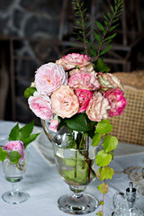 Beautiful bouquet of roses in a vase on the table.