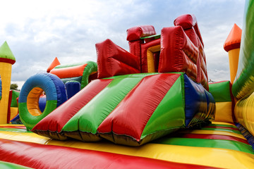 Inflatable slide for kids in playground - obrazy, fototapety, plakaty