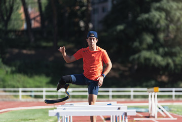 Disabled man athlete training with leg prosthesis.