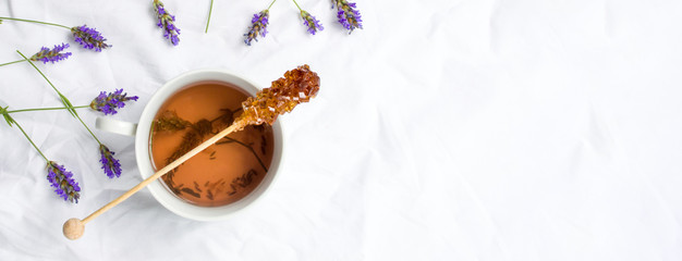 Lavender tea with fresh flowers and sugar stick