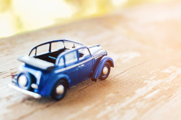 Toy vintage cabrio car on wooden background