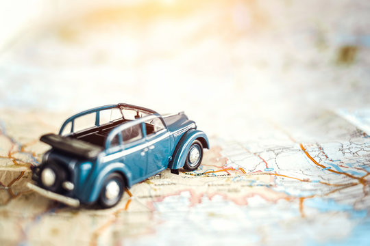 Toy retro cabrio car on the map, tourism concept - Powered by Adobe